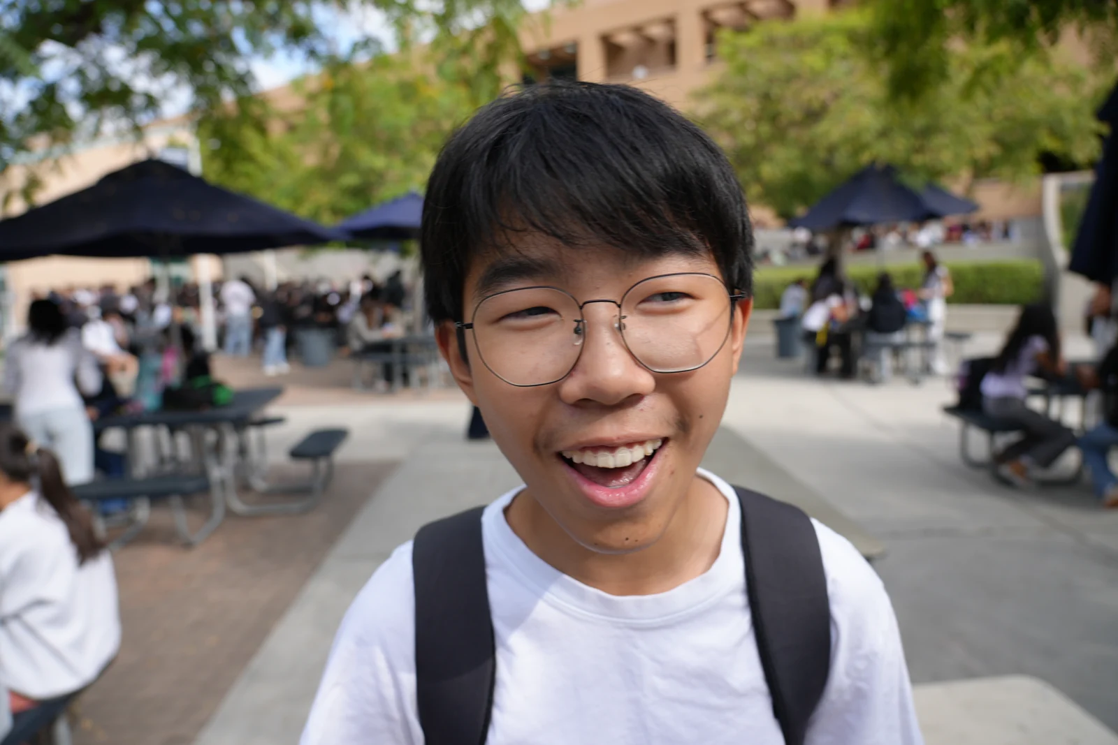 Smiling outdoors with a backpack