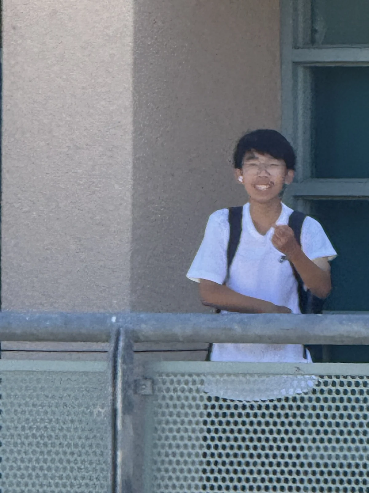 A candid moment behind an outdoor railing