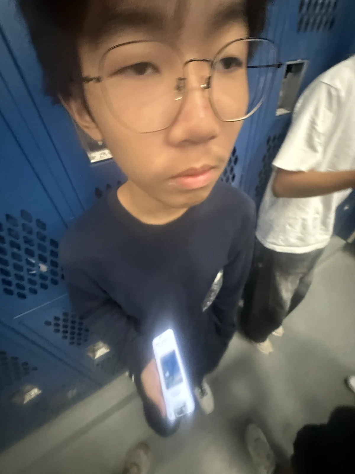 A playful wide-angle portrait by blue lockers