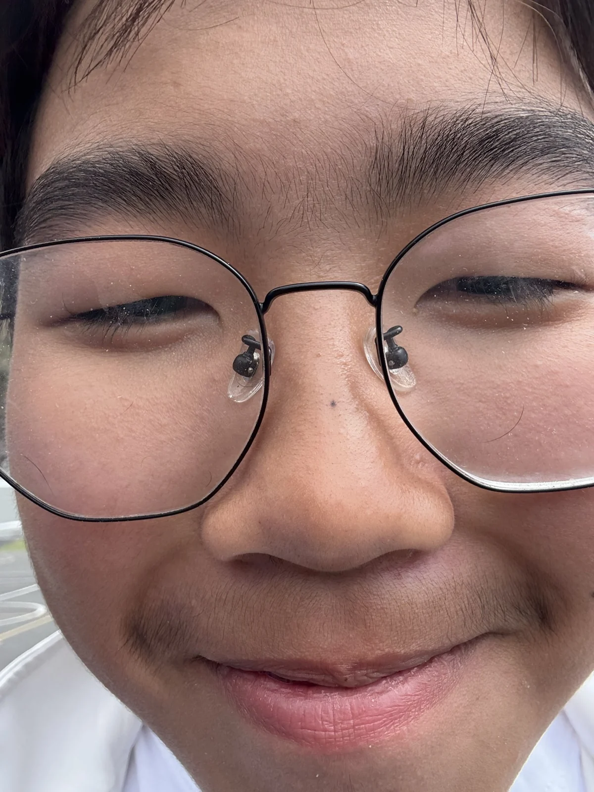 A playful smiling close-up with glasses