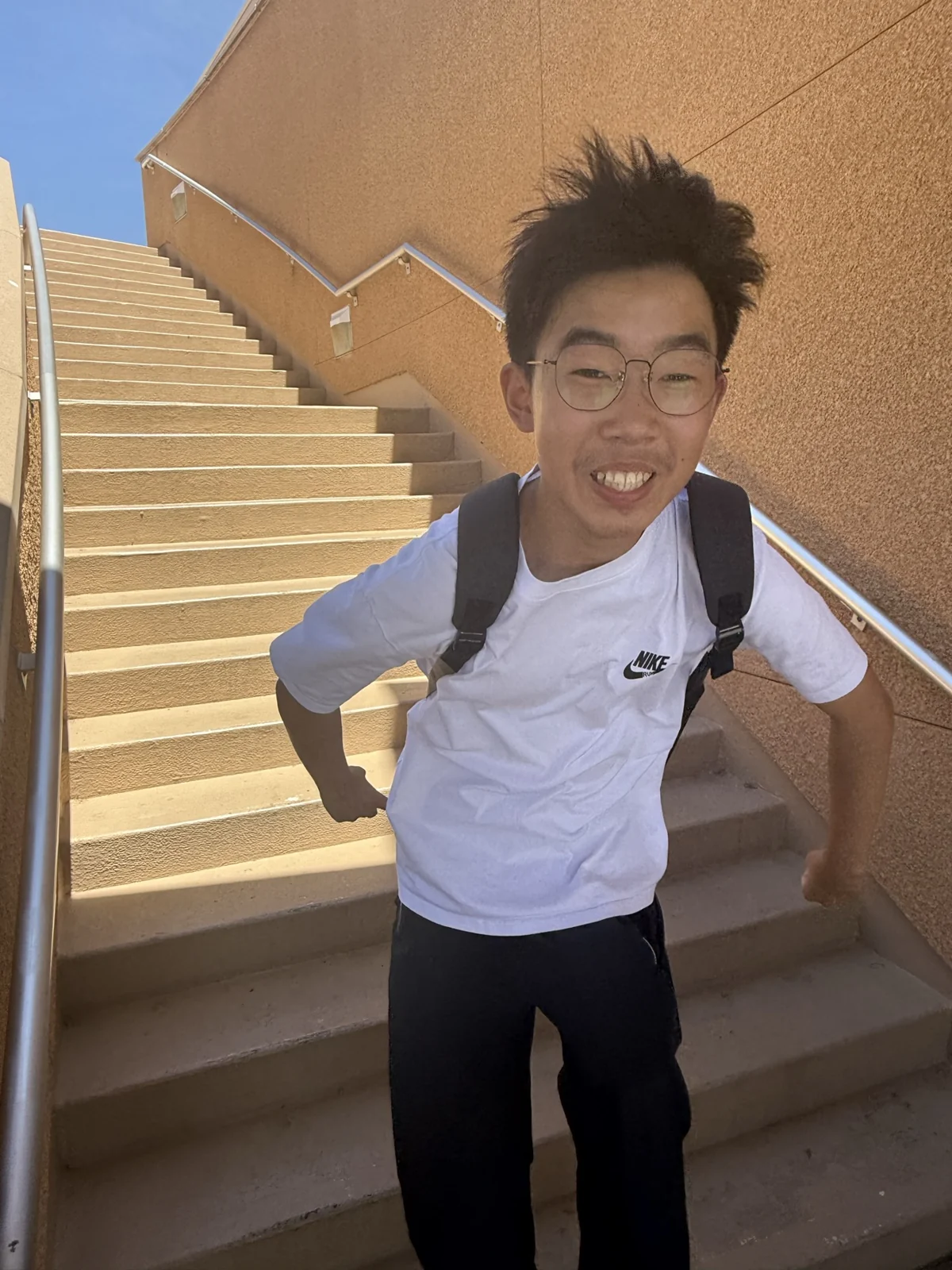 A smiling portrait on a staircase